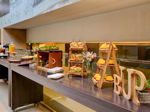 a buffet line with sandwiches and other food at Novotel RJ Santos Dumont in Rio de Janeiro