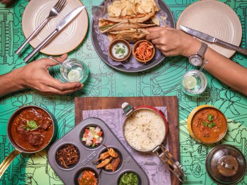 a group of people sitting at a table with food at ibis Jaipur City Centre - An Accor Brand in Jaipur