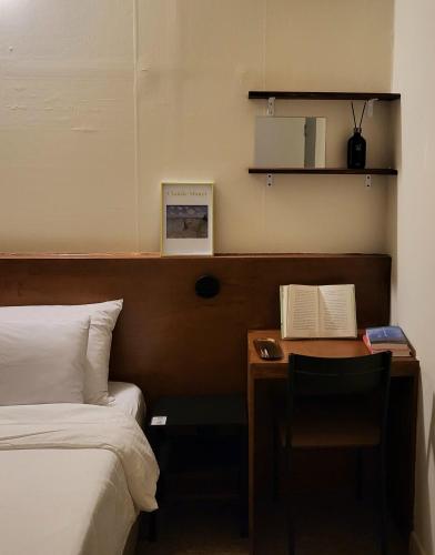 a hotel room with a desk with a bed and a desk sidx sidx sidx sidx at jeonju hotel book and type in Jeonju