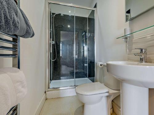 a bathroom with a shower and a toilet and a sink at 4 Bed in Bude SSHAM in Stratton