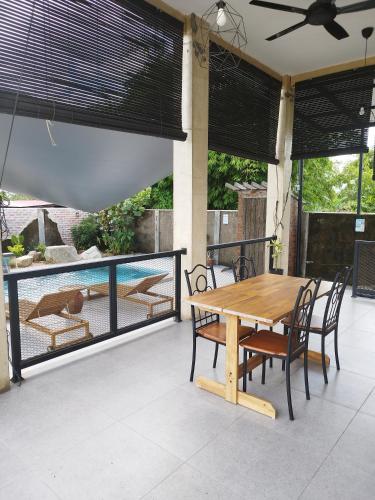 a wooden table and chairs on a patio at Lot 138 in Kota Bharu