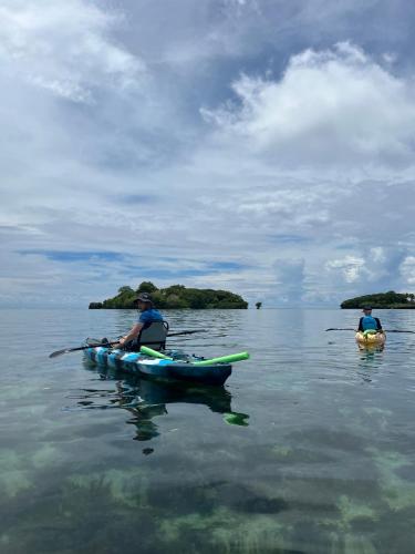 two people in kayaks on a body of water at Savusavu Salt Lake Guesthouse in Savusavu
