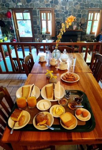 a table with plates of breakfast food on it at Hotel Semeli in Goura