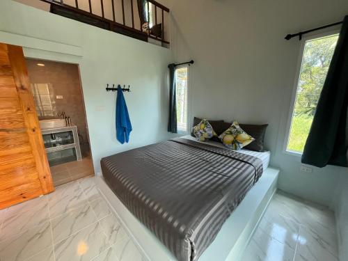 a bedroom with a bed in the corner of a room at Billabong Village in Ko Phangan