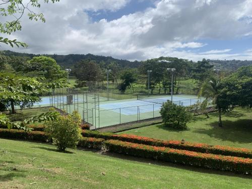 a tennis court in a park with two courts at Colina 5D 3 bdr Garden View in Los Suenos in Herradura