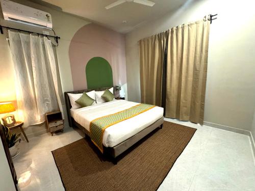 a bedroom with a large bed in a room at Nandi Daybreak - Holiday Homes in Bengaluru