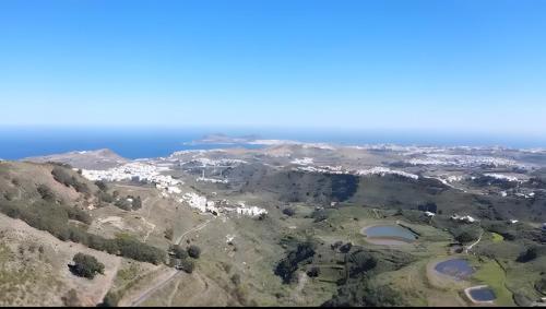 an aerial view of a town on a mountain at Ohana Villa Paula in Huertas del Palmar