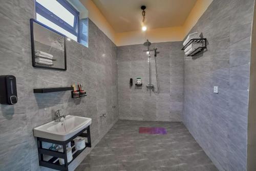 a bathroom with a sink and a shower at Samora River Lodge in Arusha