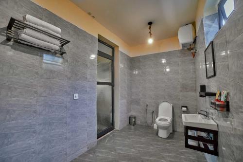 a bathroom with a toilet and a sink at Samora River Lodge in Arusha