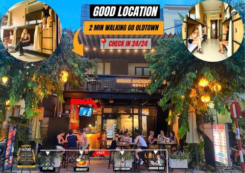 a group of people sitting outside of a building at Hoi An Ancient Town Hostel & Bar in Hoi An