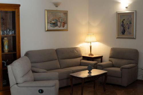 a living room with a couch and a table at Residence Acropoli in Siracusa