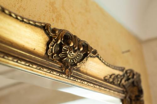 a close up of a gold frame on a mirror at Residence Acropoli in Siracusa