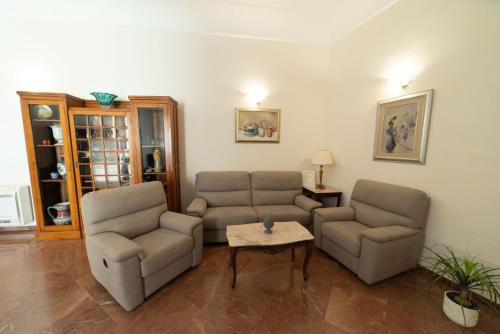 a living room with two couches and a table at Residence Acropoli in Siracusa