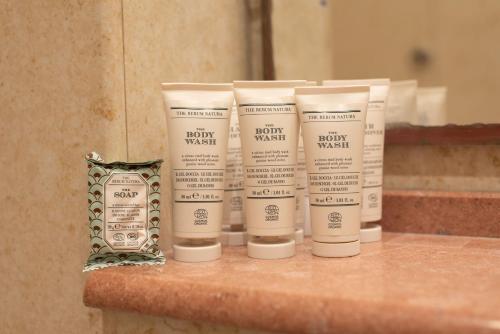 a group of four lotion bottles sitting on a counter at Residence Acropoli in Siracusa