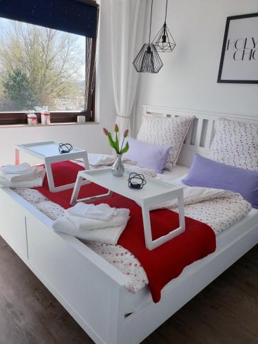 a white bed with a table on it at Edelstein am Meer in Damp