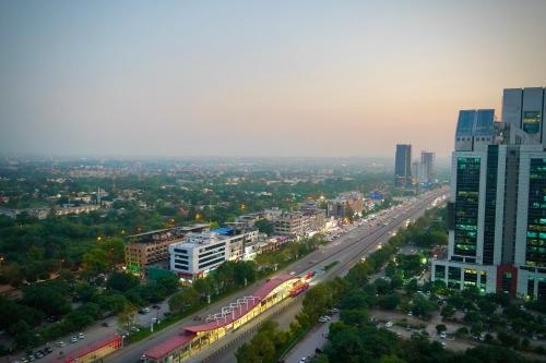 a view of a city with a highway and buildings at Central City View 1BR at Mall Of Islamabad in Islamabad