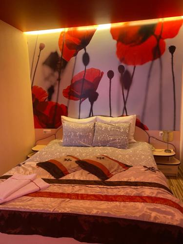 a bedroom with a bed with a painting of umbrellas at Trumpalaikė buto nuoma,apgyvendinimas - bekontaktis įėjimas in Rokiškis