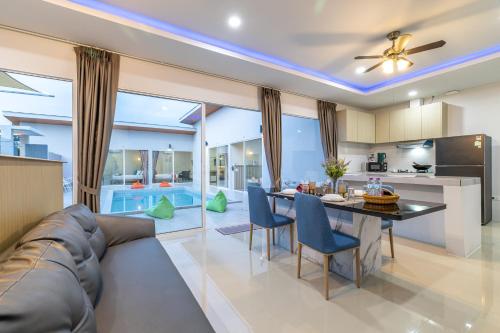 a living room with a couch and a table at Andaman Sea Best Pool Access and Villas in Phuket Town
