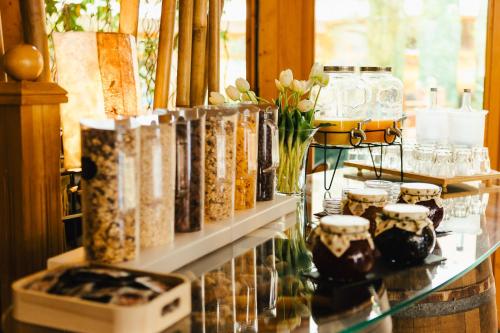 a glass counter with jars and flowers on it at Hotel Rabenstein in Raben Steinfeld