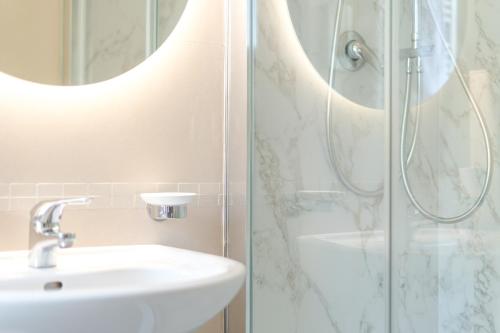 a bathroom with a sink and a shower at Hotel Ulisse in Marina Romea