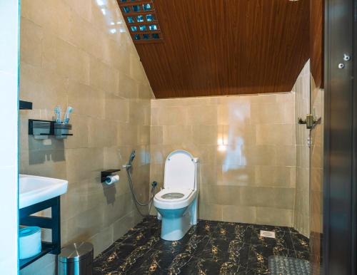 a bathroom with a toilet and a sink at Samora River Lodge in Arusha