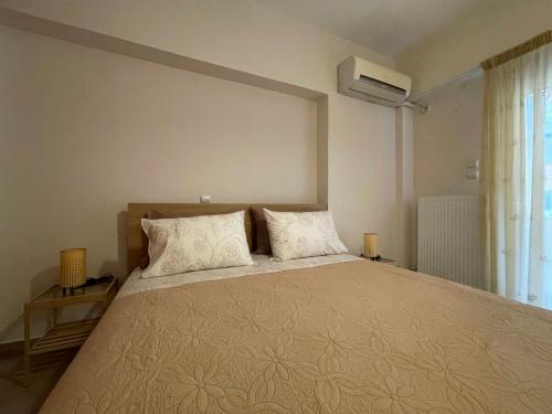 a bedroom with a large bed with two pillows at Casa Nikos in Athens