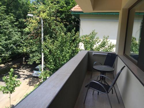 a balcony with two chairs and a table at Paradox Oituz in Eforie Sud