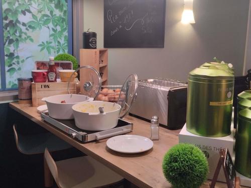 a kitchen counter with some food ingrediants on a table at ibis Dunkerque in Dunkerque