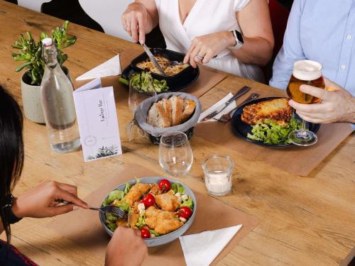 a group of people sitting at a table with food at ibis Valenciennes in Valenciennes