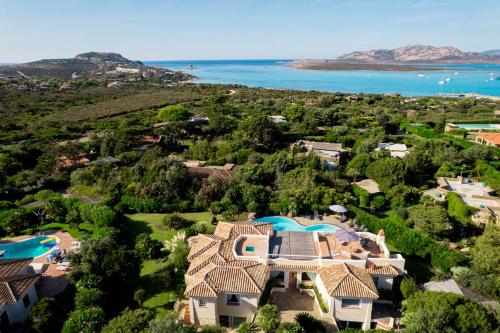 an aerial view of a house with a view of the ocean at Villa Flor, Exclusive House with Pool in Stintino in Stintino