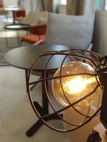 a table with a light on top of it at ibis Ciboure Saint-Jean-de-Luz in Ciboure