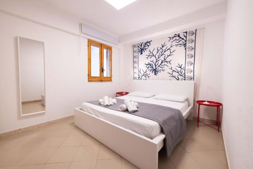 a bedroom with a bed with two stuffed animals on it at Apartment on the Beach - Large Terrace in Alcamo