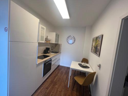 a kitchen with a white refrigerator and a table at Mara in Lübeck