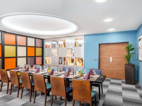 a conference room with a long table and chairs at Mercure Budapest City Center in Budapest