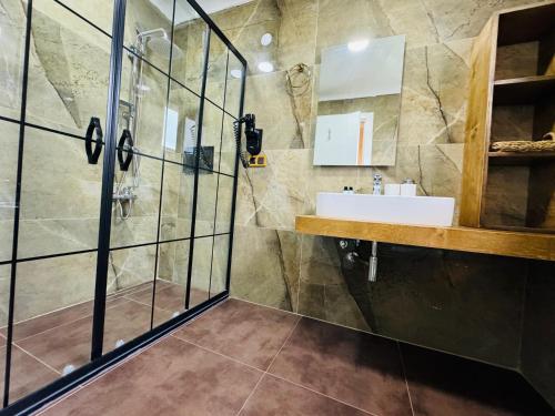 a bathroom with a sink and a shower at Treekos Suite Hotel Istanbul Airport in Arnavutköy