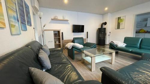 a living room with a couch and a table at Ferienhaus Loreleyresidenz Kestert in Kestert