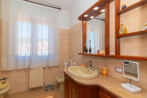 a bathroom with a sink and a mirror at La Casa in Gallura primo piano in Calangianus