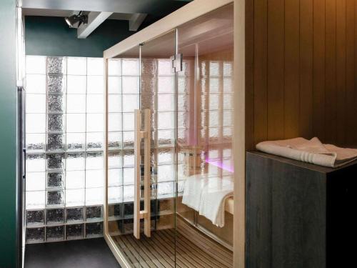 a room with a large window with a bed in it at Ibis Pontarlier in Pontarlier