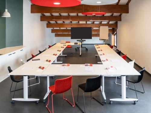 a large conference room with tables and chairs at Ibis Pontarlier in Pontarlier