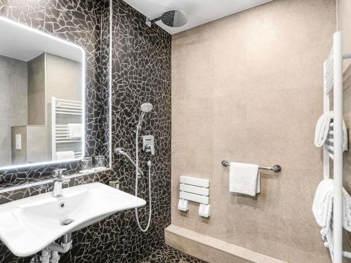 a bathroom with a sink and a shower at Ibis Budapest Heroes Square in Budapest