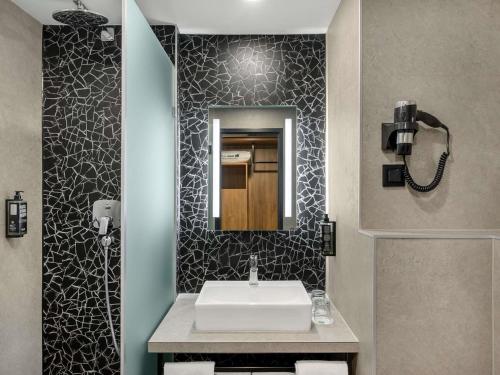 a bathroom with a sink and a mirror at Ibis Budapest Heroes Square in Budapest
