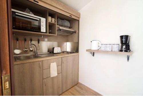 a kitchen with a sink and a microwave at Endless Blue House in Sami