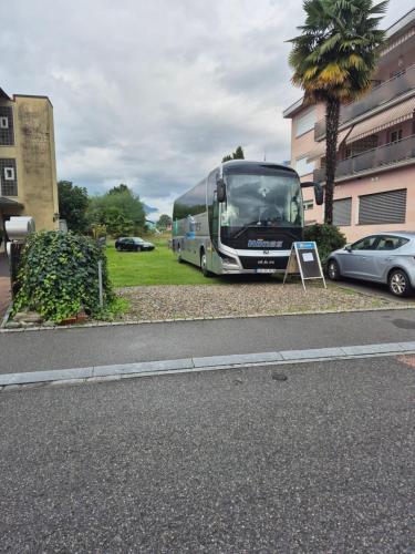 a bus is parked on the side of a street at Garni Elisabetta in Gordola