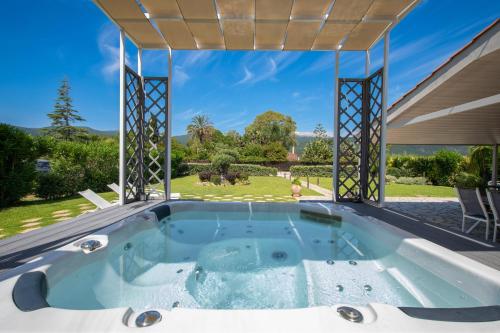 a hot tub in the backyard of a house at Endless Blue House in Sami
