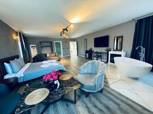 a hotel room with a bed and a bath tub at Treekos Suite Hotel Istanbul Airport in Arnavutköy