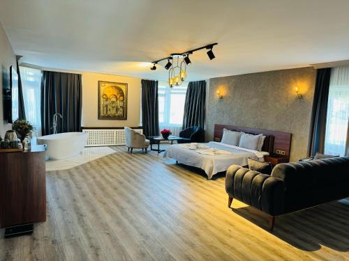 a hotel room with a bed and a bath tub at Treekos Suite Hotel Istanbul Airport in Arnavutköy