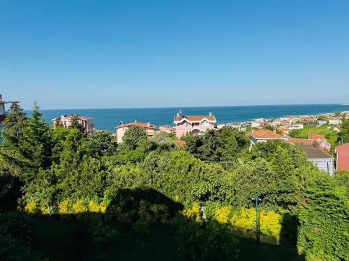 a town on top of a hill next to the ocean at Treekos Suite Hotel Istanbul Airport in Arnavutköy