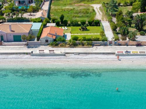 an aerial view of a beach with blue water at Endless Blue House in Sami
