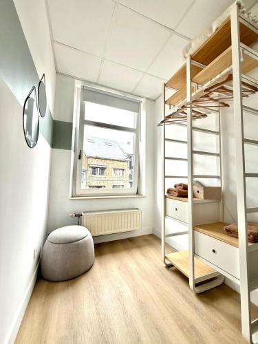 a bedroom with two bunk beds and a window at Spacious duplex in the center of Bastogne Onikos rooms in Bastogne