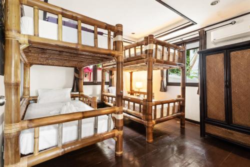 a bedroom with two bunk beds in a room at Paradise Island Estate in Choeng Mon Beach